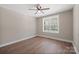 Bright bedroom featuring a ceiling fan, wood-look flooring, and a window with a view at 2518 Glenwood St, Kannapolis, NC 28083