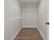 Walk-in closet with custom shelving and wood-look floors at 2518 Glenwood St, Kannapolis, NC 28083