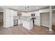 Bright kitchen with white cabinetry, stainless appliances, and a granite-topped center island at 2518 Glenwood St, Kannapolis, NC 28083