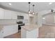 Open-concept kitchen featuring a center island, modern lighting, and stainless steel appliances at 2518 Glenwood St, Kannapolis, NC 28083