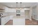 Well-lit kitchen with modern stainless appliances, white cabinets, and granite countertops at 2518 Glenwood St, Kannapolis, NC 28083
