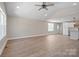 Open living room features wood floors, a ceiling fan, and natural light at 2518 Glenwood St, Kannapolis, NC 28083
