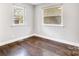 Bedroom featuring updated flooring, neutral walls, and dual windows to let in natural light at 2815 Grimes St, Charlotte, NC 28206