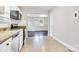 Updated kitchen featuring white cabinets, stainless steel appliances and an opening to the living room at 2815 Grimes St, Charlotte, NC 28206