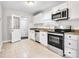Kitchen featuring white cabinets, stainless steel appliances, granite countertops, and tile flooring at 2815 Grimes St, Charlotte, NC 28206