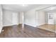 Open-concept living room featuring updated flooring and neutral walls leading into the dining and kitchen area at 2815 Grimes St, Charlotte, NC 28206