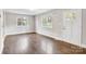 Bright living room featuring updated flooring, a large window, and a white front door at 2815 Grimes St, Charlotte, NC 28206