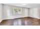 Bright living room with a large window, updated flooring, and a white front door at 2815 Grimes St, Charlotte, NC 28206