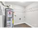 Utility room featuring a water heater, wire shelving, and washer/dryer hookups at 2815 Grimes St, Charlotte, NC 28206