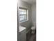 The bathroom features a new window, toilet, vanity, and flooring at 2822 Royston Rd, Charlotte, NC 28208