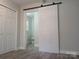 Bedroom with vinyl floors and a sliding door to the bathroom at 2822 Royston Rd, Charlotte, NC 28208