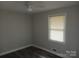 This bedroom offers a ceiling fan and a window providing natural light at 2822 Royston Rd, Charlotte, NC 28208