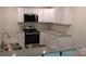 Bright kitchen featuring granite countertops, modern appliances, and white cabinetry for ample storage at 2822 Royston Rd, Charlotte, NC 28208
