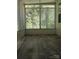 Bright sunroom with large windows and modern flooring, offering abundant natural light and outdoor views at 2822 Royston Rd, Charlotte, NC 28208