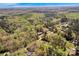 Expansive aerial view of a neighborhood surrounded by lush, green trees and blue sky at 2895 Sweeping Pine Ln, Denver, NC 28037