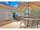 Back deck with outdoor dining set, gas grill, and a view of the lush greenery at 2895 Sweeping Pine Ln, Denver, NC 28037