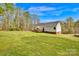Expansive backyard featuring a deck, lush lawn, and mature trees, perfect for outdoor living at 2895 Sweeping Pine Ln, Denver, NC 28037