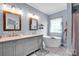 Bathroom featuring double vanity with marble countertop and soaking tub at 2895 Sweeping Pine Ln, Denver, NC 28037