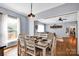 Open dining room into living room with table setting and hardwood floors at 2895 Sweeping Pine Ln, Denver, NC 28037