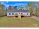 Charming single-story home featuring a freshly stained front porch and a well-maintained yard in a tranquil setting at 2895 Sweeping Pine Ln, Denver, NC 28037