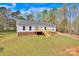 Exterior view of a cozy home featuring a well-kept lawn and wooden deck at 2895 Sweeping Pine Ln, Denver, NC 28037