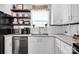 Close-up of a well-organized kitchen featuring stainless steel appliances, granite counters, and ample storage space at 2895 Sweeping Pine Ln, Denver, NC 28037