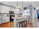 Bright and airy kitchen showcasing an island with seating and granite countertops, flowing into the adjacent dining area at 2895 Sweeping Pine Ln, Denver, NC 28037