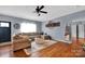 Well-lit living room with hardwood flooring, stylish furnishings, and an open layout for flexible living spaces at 2895 Sweeping Pine Ln, Denver, NC 28037