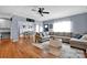 Open-concept living room flowing into the dining area, featuring hardwood floors, modern decor, and ample natural light at 2895 Sweeping Pine Ln, Denver, NC 28037