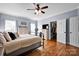 Spacious main bedroom featuring wood floors, a ceiling fan, and walk-in closet at 2895 Sweeping Pine Ln, Denver, NC 28037