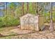 Exterior view of a wooden shed in a wooded backyard setting at 2895 Sweeping Pine Ln, Denver, NC 28037