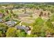 Aerial view of the property with mature trees and foliage, with a golf course in the background at 316 Country Club Acres None, Shelby, NC 28150