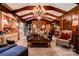 Living room featuring wood paneled walls and ceiling, with a large bookcase at 316 Country Club Acres None, Shelby, NC 28150