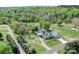 An elevated view of a blue house surrounded by lush, mature landscaping and a sprawling lawn at 3241 Long Shoals Rd, Lincolnton, NC 28092
