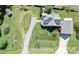 Birds-eye view of a house with a sprawling yard, gravel driveway, and meticulously maintained landscaping at 3241 Long Shoals Rd, Lincolnton, NC 28092