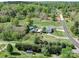 Wide aerial shot of blue house with plentiful surrounding land and mature trees at 3241 Long Shoals Rd, Lincolnton, NC 28092