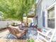 Inviting back patio featuring outdoor seating, a tree for shade, and access to the backyard at 3241 Long Shoals Rd, Lincolnton, NC 28092
