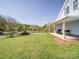 Expansive backyard with a covered patio, lush green grass, and privacy, perfect for outdoor enjoyment at 3241 Long Shoals Rd, Lincolnton, NC 28092