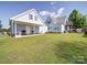 Spacious backyard featuring a well-maintained lawn, covered porch, and mature trees at 3241 Long Shoals Rd, Lincolnton, NC 28092