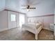 Bright bedroom featuring plush carpet, charming wallpaper, a cozy bed, and plenty of natural light at 3241 Long Shoals Rd, Lincolnton, NC 28092