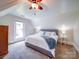 Inviting bedroom with plush carpeting, a cozy bed with throw blanket, and lots of natural light at 3241 Long Shoals Rd, Lincolnton, NC 28092