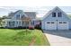 Charming blue two-story home with an attached two-car garage and well-manicured lawn at 3241 Long Shoals Rd, Lincolnton, NC 28092