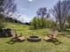 Cozy backyard firepit area with Adirondack chairs, perfect for outdoor gatherings and relaxation at 3241 Long Shoals Rd, Lincolnton, NC 28092