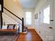 Inviting foyer with hardwood floors, bench seating, and a staircase with charming details at 3241 Long Shoals Rd, Lincolnton, NC 28092