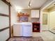 Well-equipped laundry room with washer, dryer, decorative accents, and sliding barn door at 3241 Long Shoals Rd, Lincolnton, NC 28092