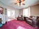 Cozy living room featuring a fireplace, plush chairs, and lots of natural light at 3241 Long Shoals Rd, Lincolnton, NC 28092