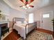 Cozy main bedroom with hardwood floors, fireplace, and a comfortable iron bed frame at 3241 Long Shoals Rd, Lincolnton, NC 28092