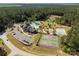 Aerial view of community amenities featuring a pool, clubhouse, tennis courts, playground, and scenic pond with fountain at 3268 Sherman Dr, Lancaster, SC 29720