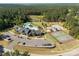 Aerial view showcasing community amenities including a pool, playground, clubhouse, tennis courts, and beautiful pond at 3268 Sherman Dr, Lancaster, SC 29720