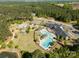 Aerial view featuring a community pool, clubhouse, playground, tennis courts, and landscaped green spaces for recreation at 3268 Sherman Dr, Lancaster, SC 29720